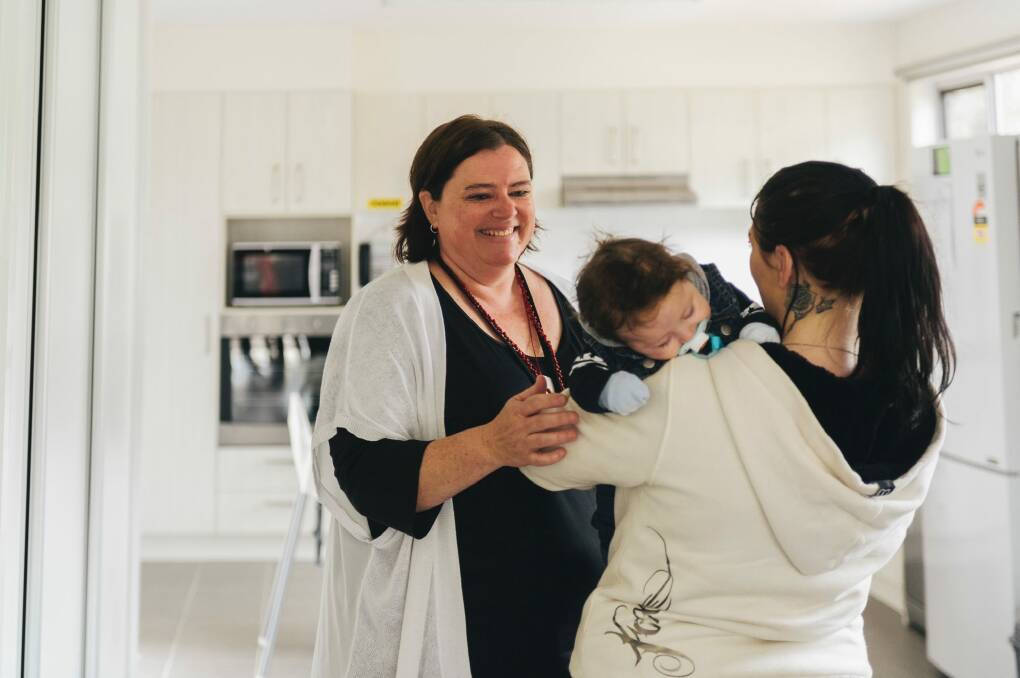 The new Karinya House for vulnerable mothers and babies was officially opened in Belconnen on Wednesday. Case worker Catherine O'Halloran is pictured here with a 20-year-old resident and her three-month-old son.

 Photo: Rohan Thomson