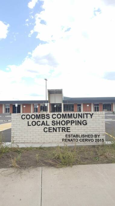 Residents say the sign outside the yet-to-be-finished Coombs shopping centre graphically illustrates their long wait for local shops. Photo: supplied