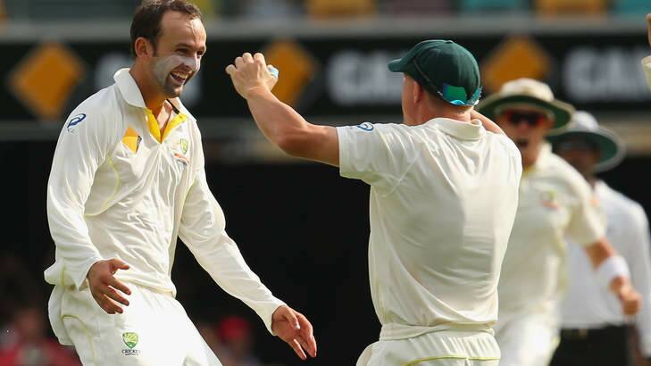 Nathan Lyon and David Warner celebrate after taking a wicket during day four of the First Ashes Test. Photo: Getty Images