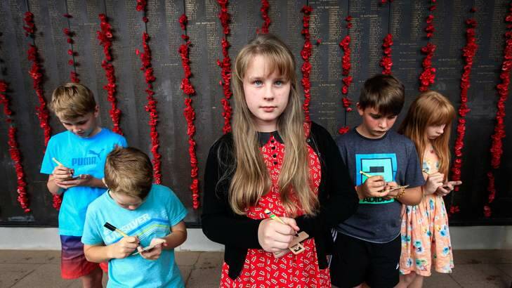 These special Anzac Day messages written on wooden crosses are part of an extensive centenary program by the Memorial aimed at placing almost 100,000 crosses on the overseas war graves of Australians during the next four commemorative years of the First World War. (From left) Blake Bennie age 11, Austin Bennie age 7, Eliza Niven age 12, Matthew Rutter age 11 and Tessa Niven age 10. Photo: Katherine Griffiths