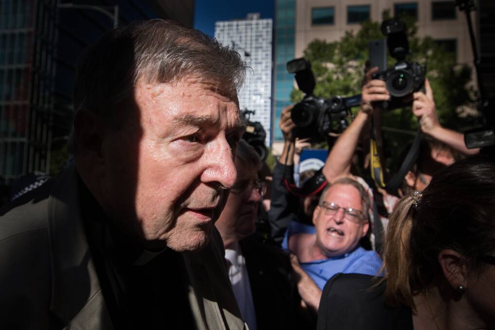 George Pell outside Victoria's County Court, where hecklers yelled that the cardinal was going to "burn" and "rot" in hell. Photo: Jason South