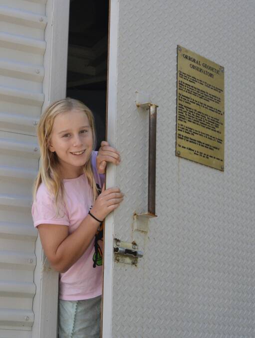 Sarah, Tim’s 11-year old daughter, peeks out of the historic observatory. Photo: Tim the Yowie Man
