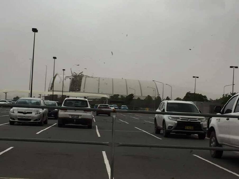 Part of the roof of a Canberra Airport hangar was ripped off during Friday's brief storm. Photo: Facebook