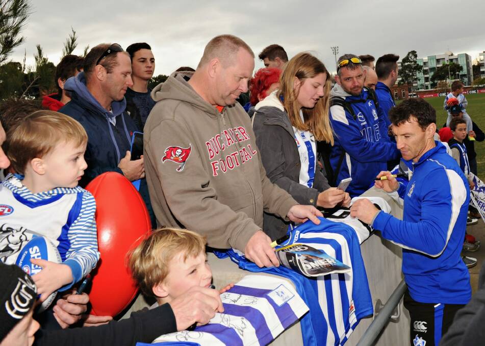 Popular: Brent Harvey signs autographs after training on Friday. Photo: Vince Caligiuri