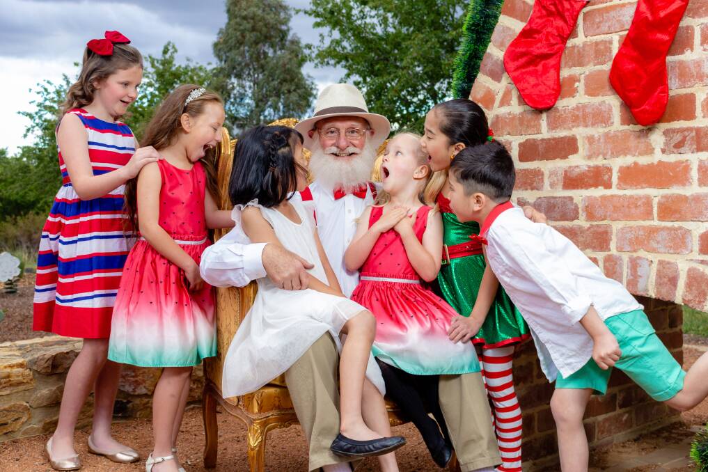 Cliff White, centre, as the self-proclaimed Santa Claus in <i>Miracle on 34th Street Canberra</i>. Photo: Greg Gould