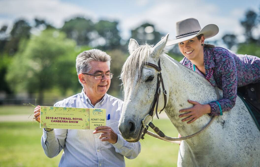 New Royal Canberra Show chief executive Athol Chalmers and chief horse steward Brooke Keir, with Izzie the horse and a cheaper ticket to next year's show. Photo: Karleen Minney