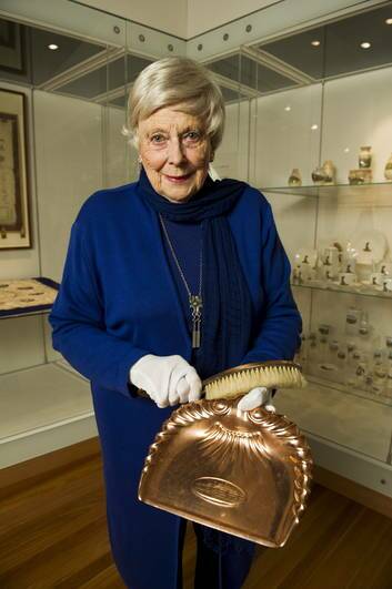 Dawn Waterhouse with a Parliament House souvenir dust pan and brush. Waterhouse, is showing off her collection of Canberra souvenirs at the Canberra Museum and Gallery. Photo: Rohan Thomson