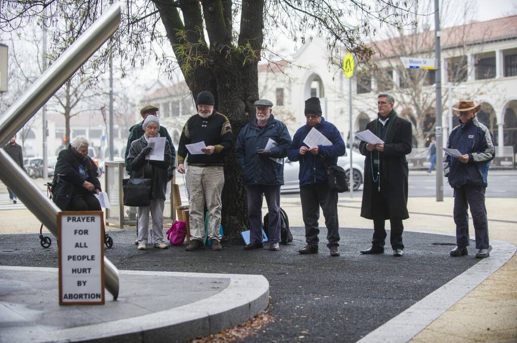Anti-abortion campaigners, including Right to Life members, at their regular prayer vigil outside the ACT abortion clinic on Friday. Photo: Rohan Thomson