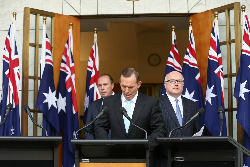 Prime Minister Tony Abbott with Immigration Minister Peter Dutton and Attorney-General George Brandis during a joint press conference at Parliament House on Tuesday.  Photo: Alex Ellinghausen