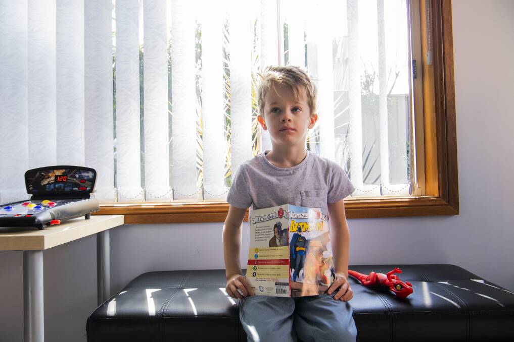 Mary Gabbey's son Henry likes the variety of topics he can explore on weekly visits to the library. Photo: Louise Kennerley