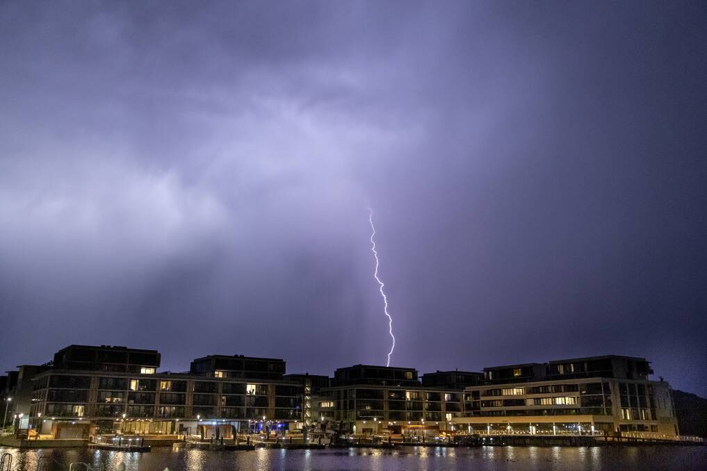 Lightning flashes over the Kingston Foreshore on Thursday night. Photo: Sitthixay Ditthavong