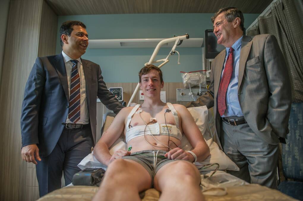 Tarran Savage with Dr Rajeev Kumar Pathak and Dr Peter French, the cardiologists who were able to reverse his condition after he went into cardiac arrest on the soccer field. Photo: karleen minney