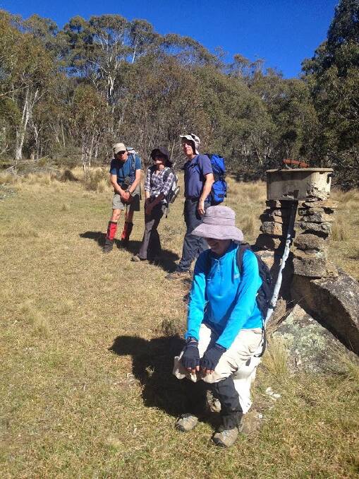 Bushwalkers line-up for the obligatory photo sitting on Aboud's dunny. Photo: John Evans