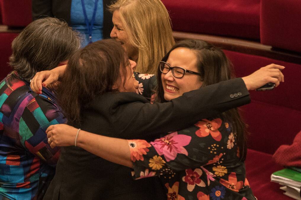 Members of the Victorian Upper house celebrate with hugs and tears of joy after a marathon 29 hours sitting to pass the Voluntary Assisted Dying Bill in November 2017.  Photo: Jason South