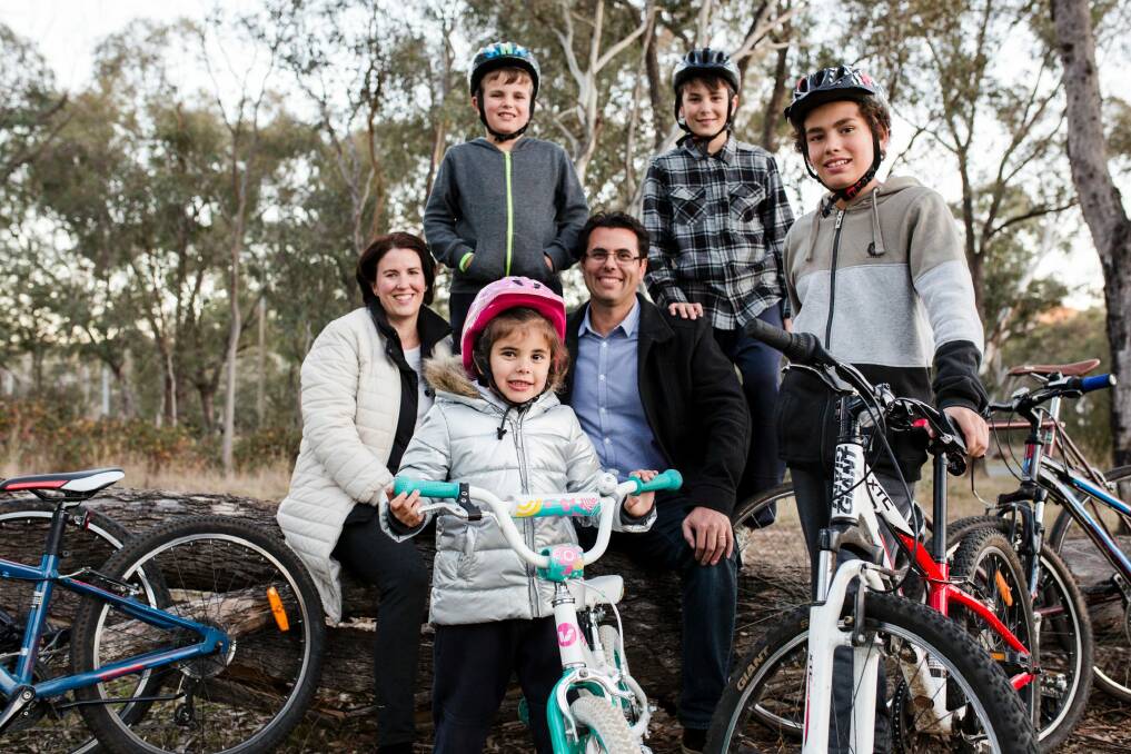 The government will announce funding for more cycle paths in next week's ACT budget. Kate and Liam Osborne with their kids, (front) Olivia 5, and Patrick 12, (back) Liam 8, and Ryan 10. Photo: Jamila Toderas