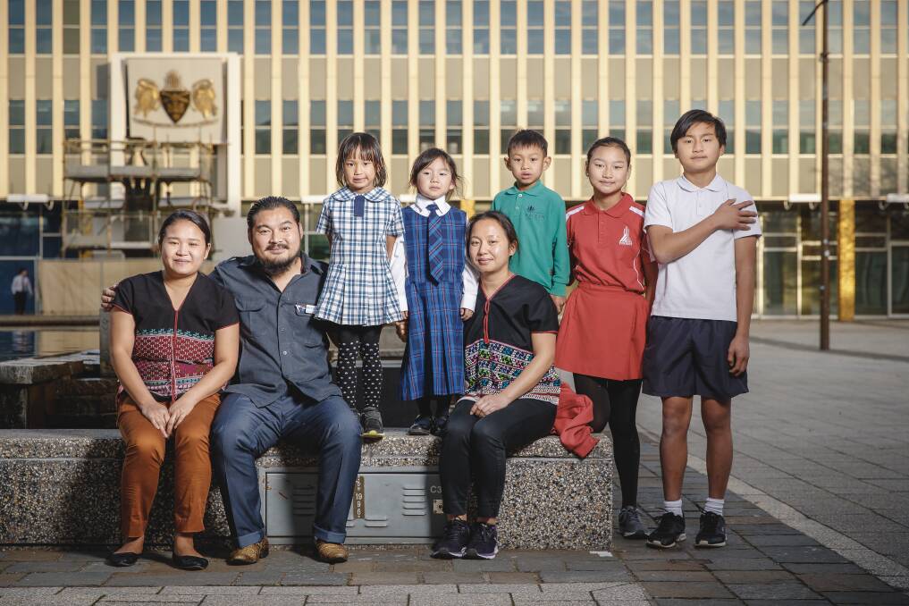 The family, some of them Canberra-born, are thriving in the capital. (From left) Lah Gray Paw, Moo K'Lue Di Gay, Olivia A Sein, Emiliana Di Gay, Rebecca Di Gay, Antonious A Sein, Eh Tha Yu Htoo Di Gay, and Kyaw Kyaw Poe Di Gay.  Photo: Sitthixay Ditthavong
