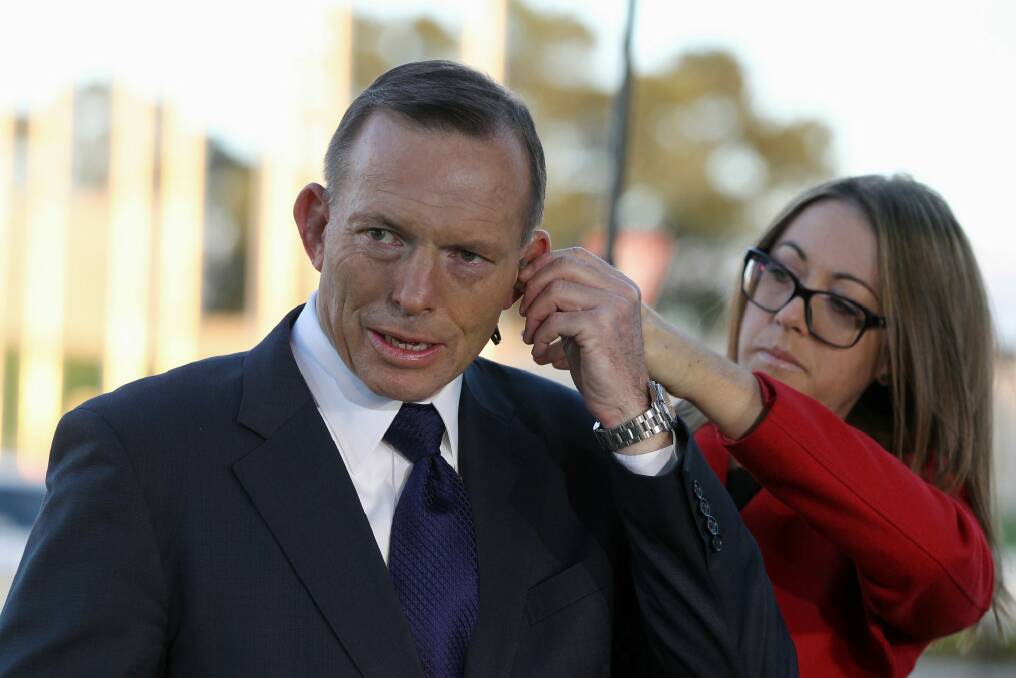 Prime Minister Tony Abbott gets ready for breakfast TV interviews. Photo: Alex Ellinghausen