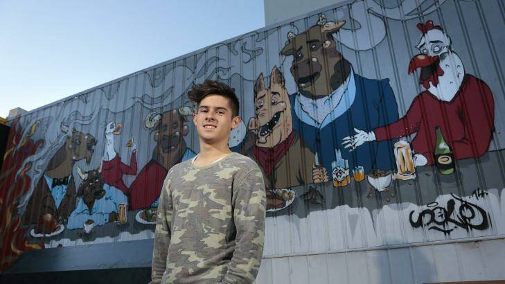 Solomon Grainger, 16, with the feature artwork in the courtyard of Hopscotch bar in Braddon. Photo: Jeffrey Chan