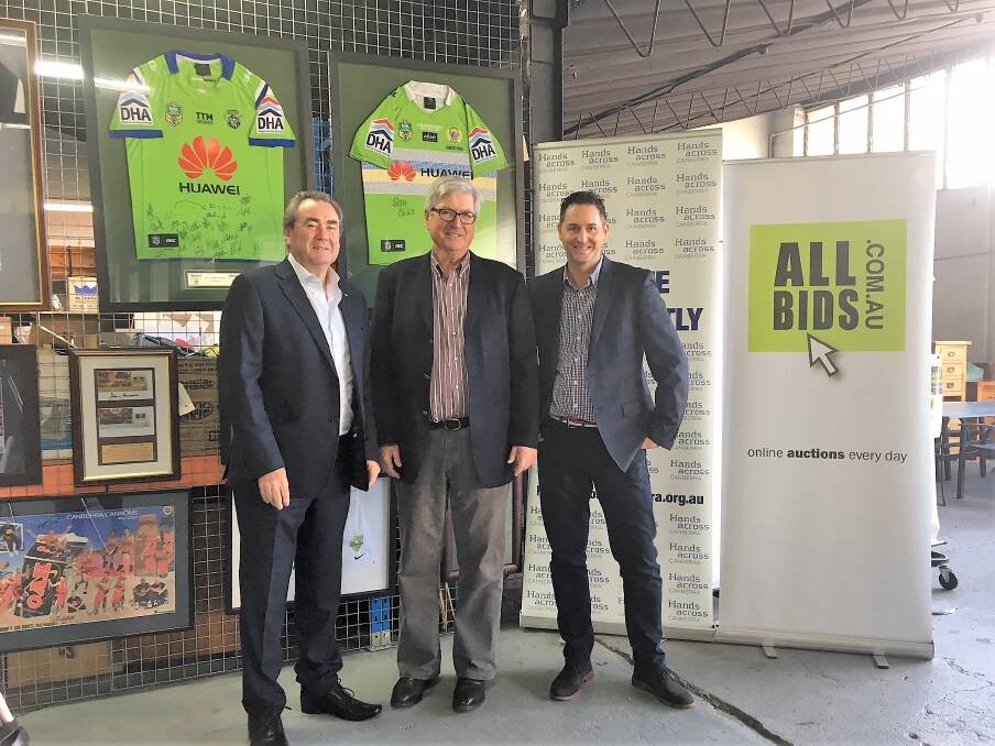 ActewAGL’s Paul Walshe, Hands Across Canberra CEO Peter Gordon and Allbids Auctions CEO Rob Evans with some of the items. Photo: Supplied