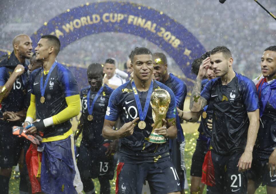 France's Kylian Mbappe celebrates with the trophy after the final match between France and Croatia at the 2018 soccer World Cup Photo: AP