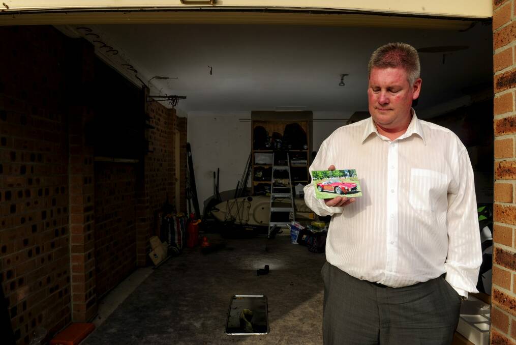 Darren McKittrick, of Palmerston, in his garage with a photograph of his '97 Shelby Cobra, which was stolen at the weekend. Photo: Melissa Adams