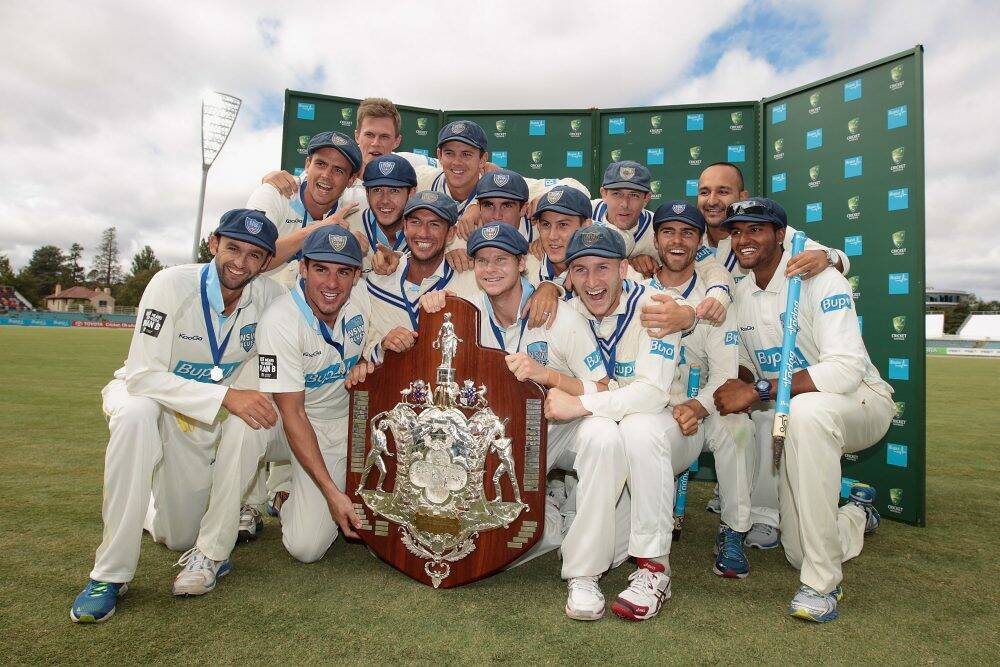 The NSW Blues celebrate their Sheffield Shield triumph at Manuka Oval.