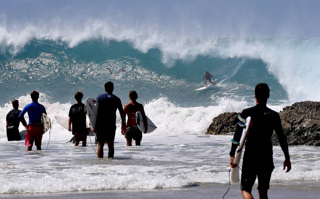 Surfers make the most of large surf at Snapper Rocks on the Gold Coast on Thursday. Photo: Dave Hunt/AAP.