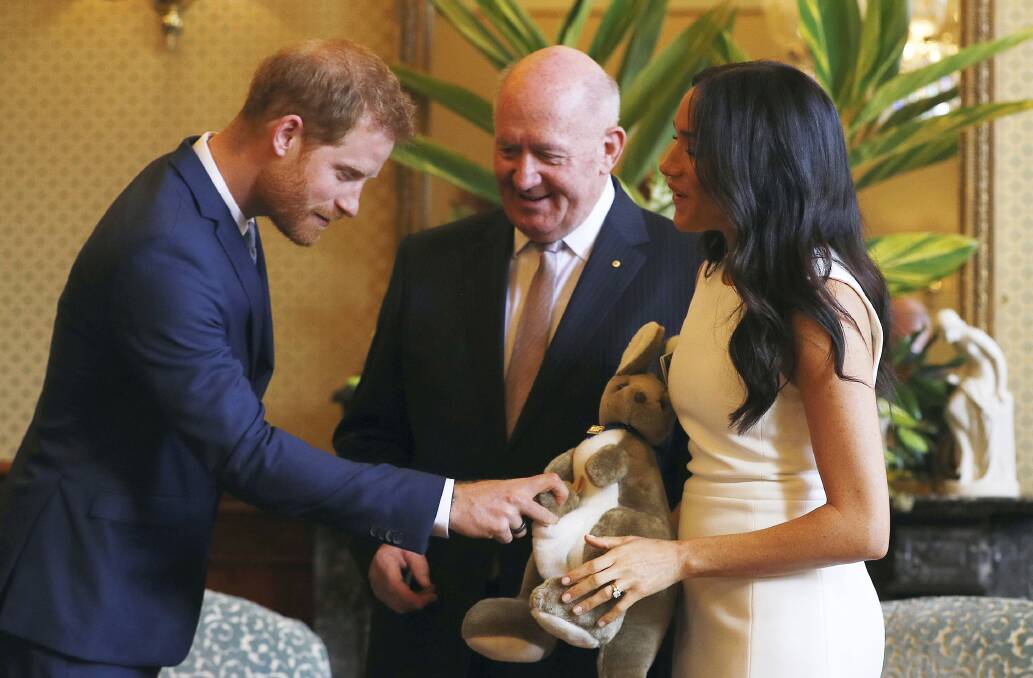 Governor-General Sir Peter Cosgrove, centre, with Britain's Prince Harry, left, and Meghan, Duchess of Sussex. Photo: Phil Noble