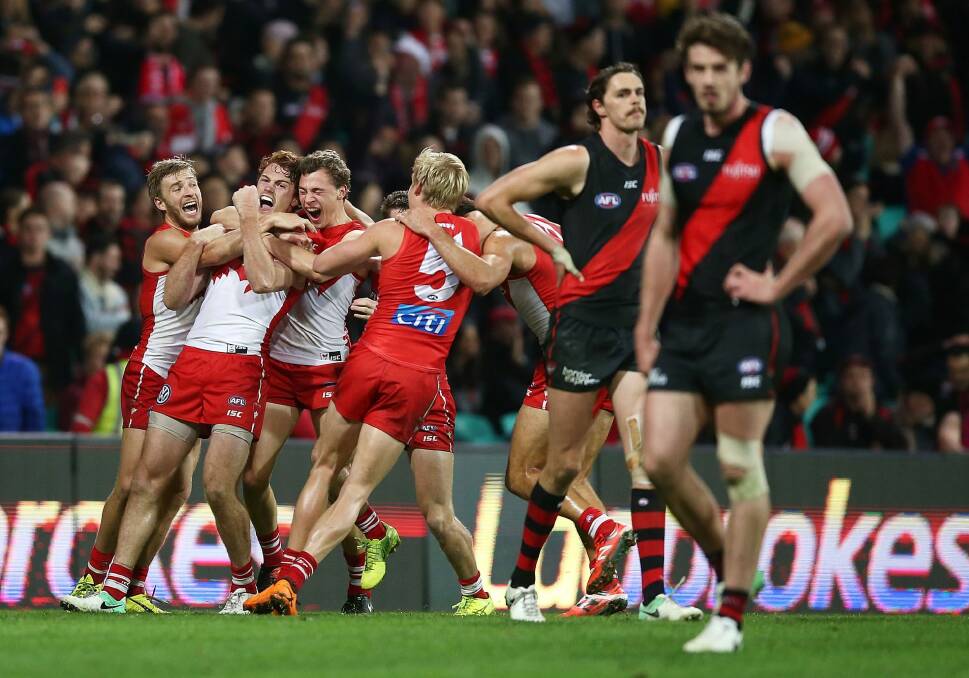 Gary Rohan celebrates with team mates after kicking a goal to win the match during the round 14 AFL match between the Sydney Swans and the Essendon Bombers. Photo: Getty Images