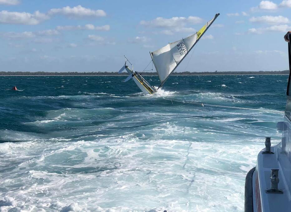 A woman spent at least two hours clinging to her overturned 14-foot catamaran off Hervey Bay on Sunday. Photo: Volunteer Marine Rescue Hervey Bay - Facebook