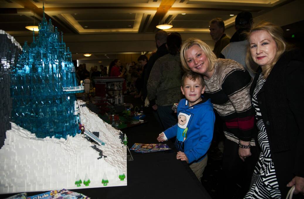 Michael Broomham, 6, with his mother Teresa Broomham and grandmother Pam Lichtenberg, all of Wollongong, next to the Lego Frozen castle.  Photo: Elesa Kurtz