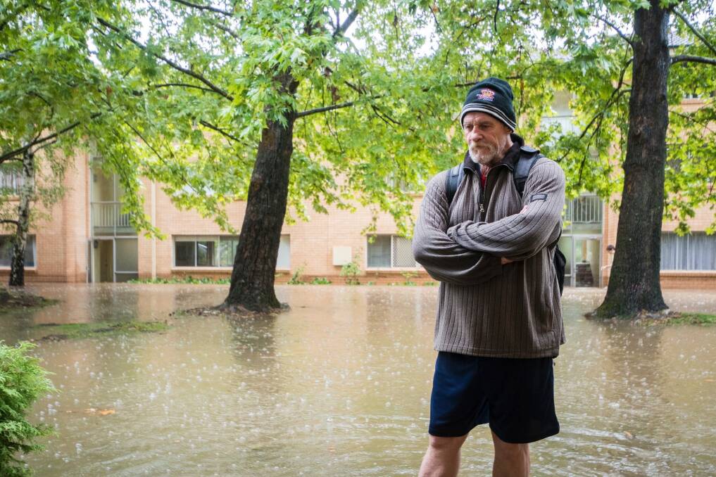 Gary Carter stands outside his flooded apartment at O'Connor.  Photo: Dion Georgopoulos