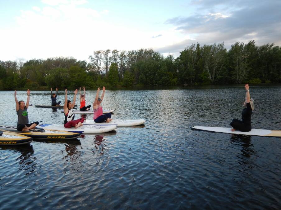 Stand-up paddleboard yoga with Jo Flynn from Joga Yoga on Lake Burley Griffin. Photo: Supplied