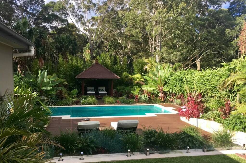 At Bali By The Bay, an undercover deck area with a wood fire pizza oven overlooks the pool. Photo: Airbnb