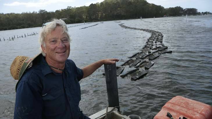 Job with a view: Kevin McAsh at the 20-hectare oyster farm near Batemans Bay. Photo: Jeffrey Chan
