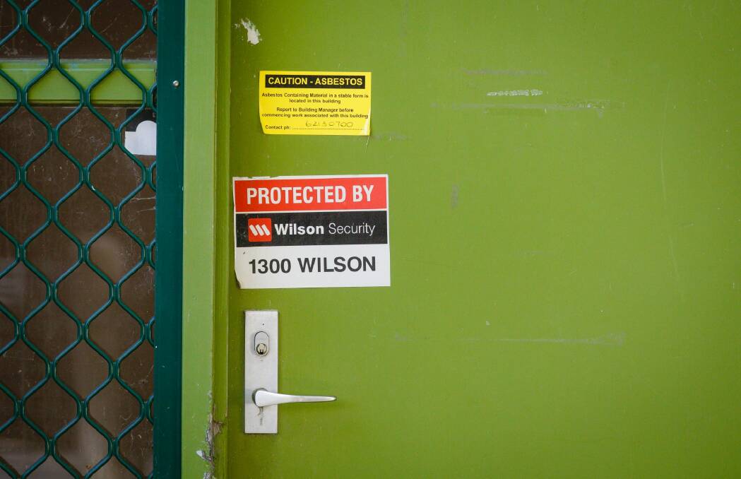 A yellow sign at this house in Wakefield Gardens Ainslie warns of the presence of asbestos. Photo: Sitthixay Ditthavong