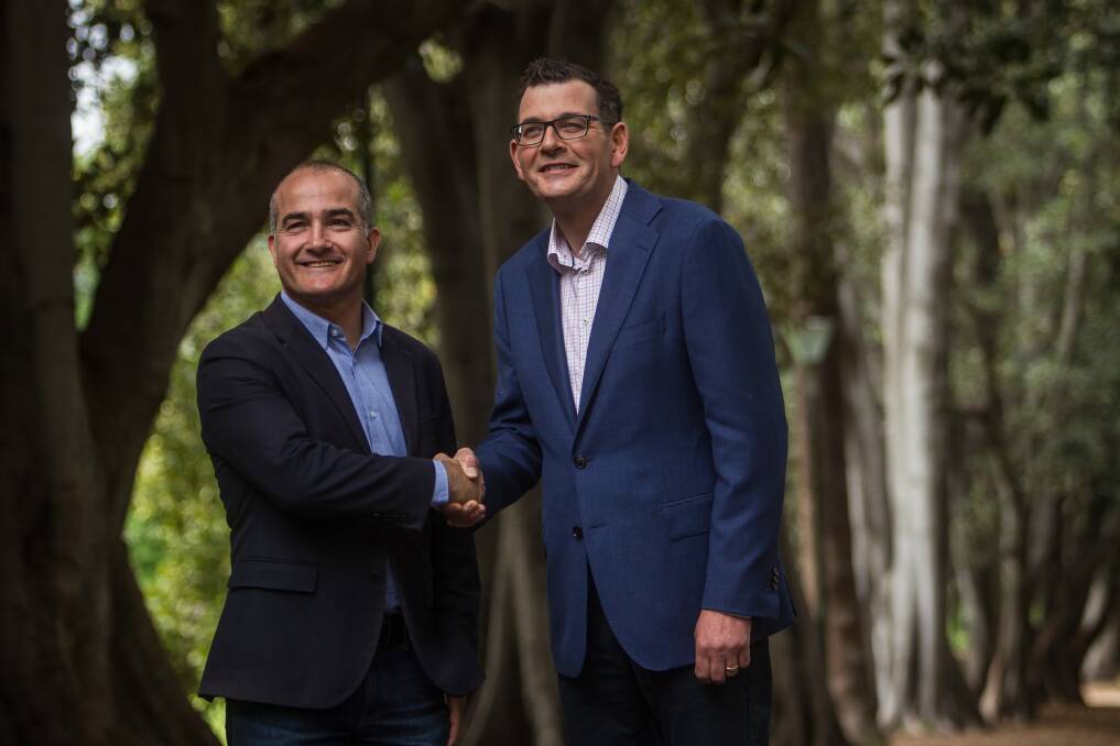 A jubilant re-elected Premier Daniel Andrews (right) on a Sunday stroll with his deputy and friend James Merlino. Photo: Scott McNaughton