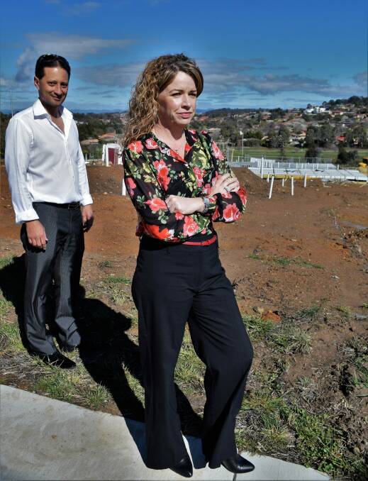 Kerrianne Abbott [foreground] with Gold Ruby Homes director Matthew Smith at the site of her new home. Photo: David Ellery