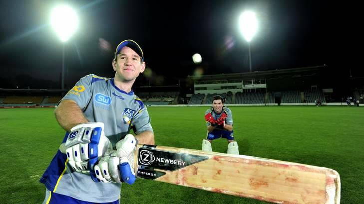 ACT Comets batsman Aaron Ayre,20 of Turner and wicket keeper, Beau McClintock,19 of Harrison under the new light at Manuka oval that were turned on for the first time. Photo: Melissa Adams