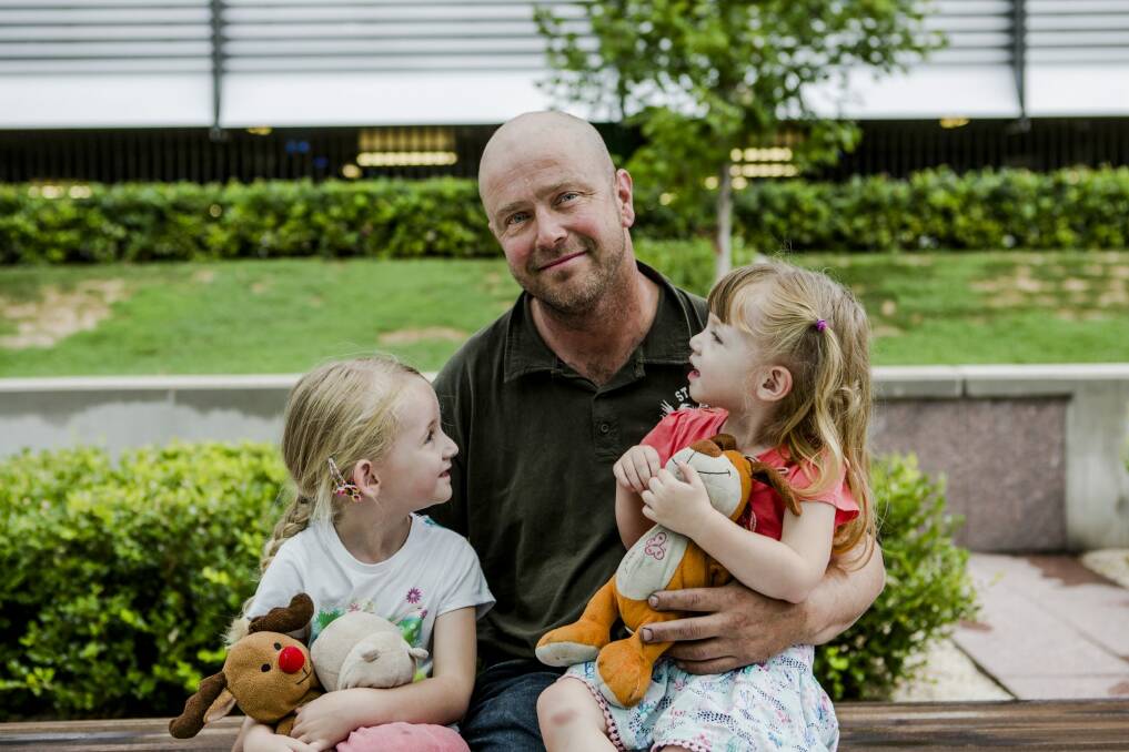 Returning ACT Remote Area Firefighter Terry Dwyer with his daughters Hannnah, 5 and Emily, 2. 
 Photo: Jamila Toderas