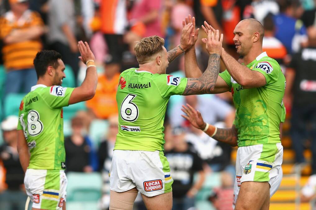 Raiders players celebrate after their big comeback win over Wests Tigers at Leichhardt Oval.  Photo: Cameron Spencer