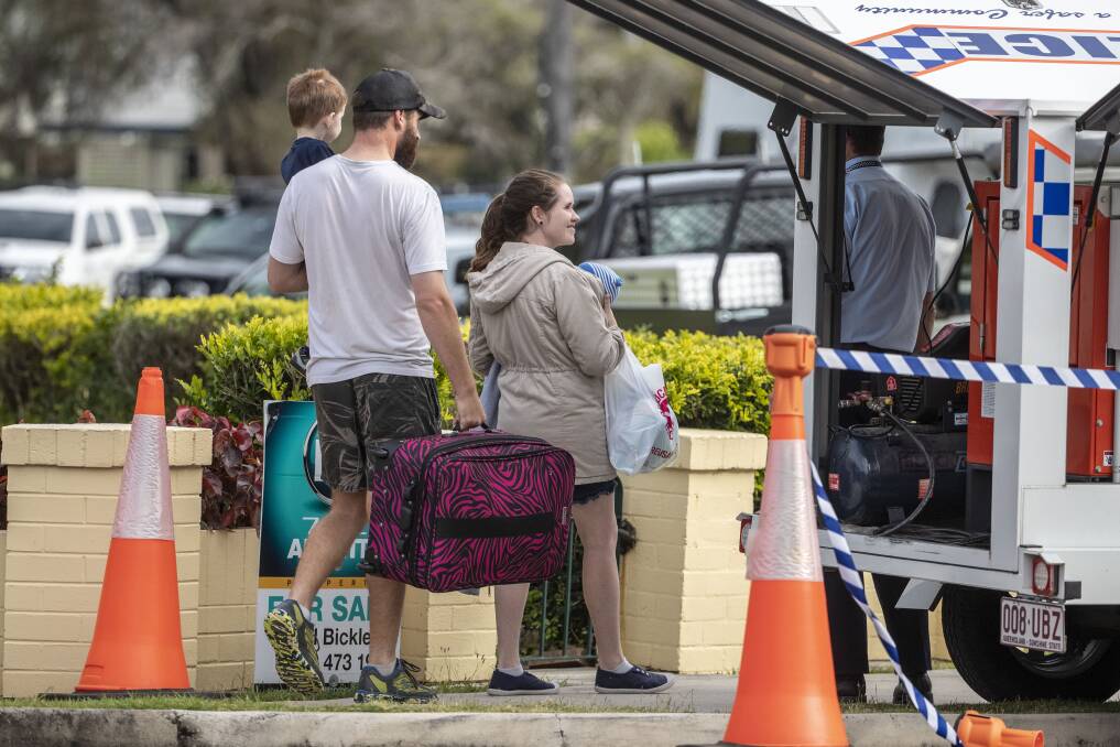 A family was evacuated by police from the area with the siege surpassing the 24-hour mark. Photo: AAP - Glenn Hunt