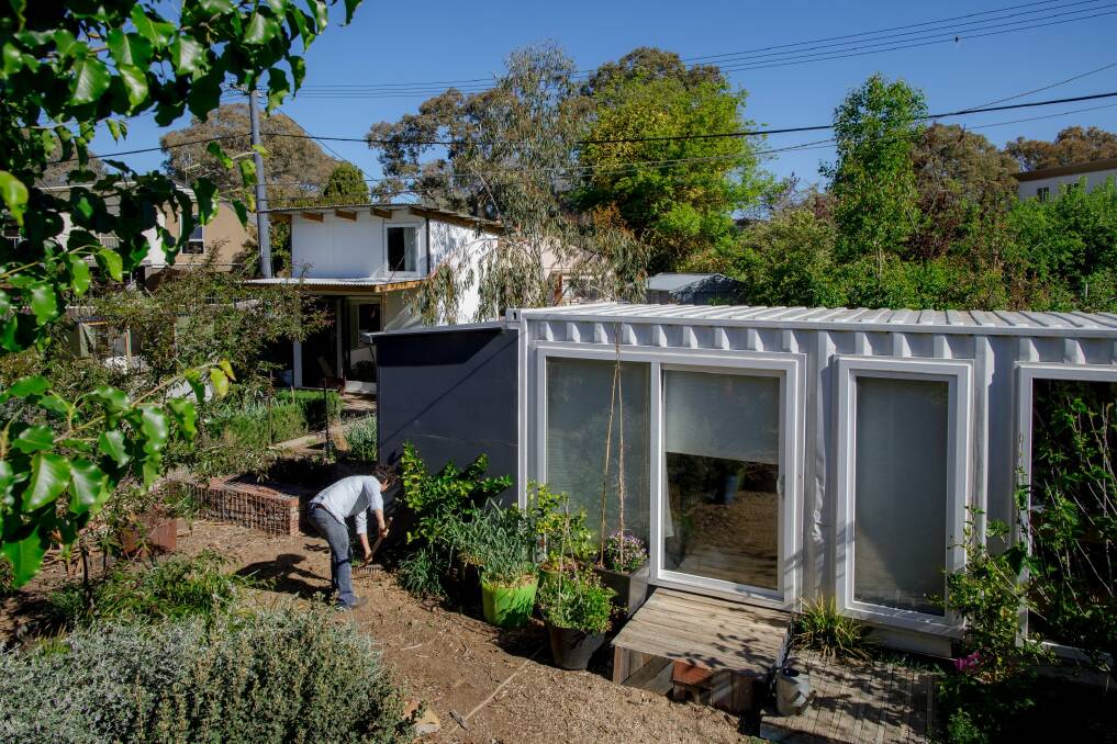 Edwina Robinson and two micro-houses in O'Connor built by her son.  Photo: Sitthixay Ditthavong