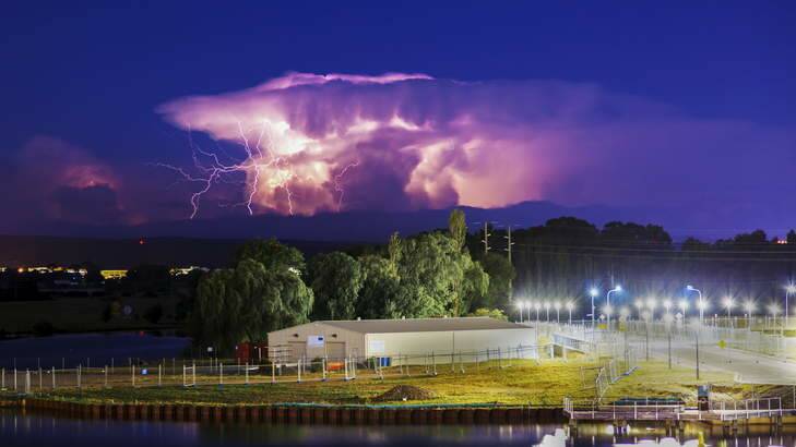 STUNNING ILLUMINATION: No such thing as the dark of night as a lightning storm passed by Canberra very early on Saturday. Photo: Jonathan McFeat