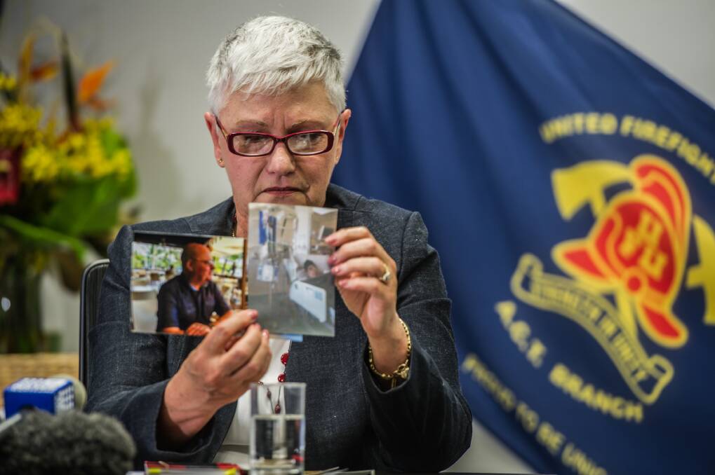 Robyn Wood, the widow of ACT firefighter Ken Wood, holds photos showing Mr Wood before and after his cancer diagnoses. Photo: Karleen Minney