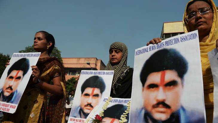 Indian activists pose with pictures of  the Sarabjit Singh in Kolkata on Thursday. Photo: AFP