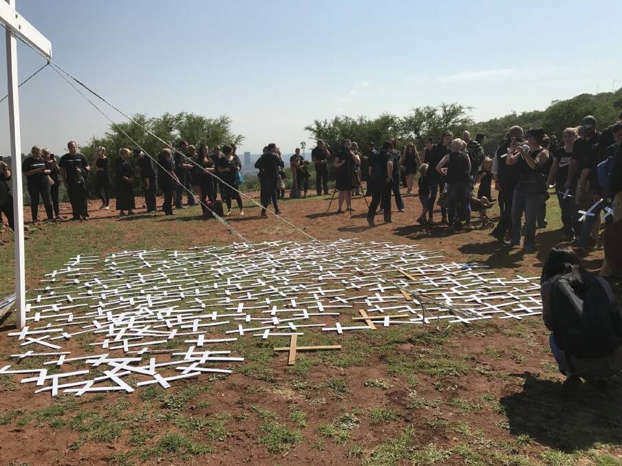 Protesters lay 'cross' symbols on the ground to protest against farmer murders in the country.  Photo: Nadya Pretorius