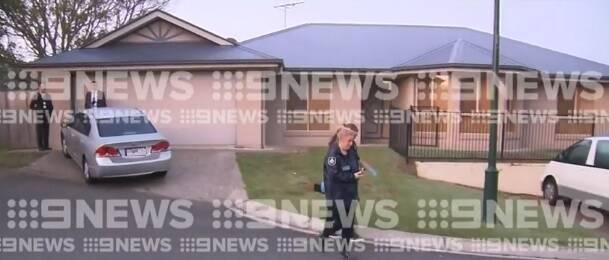 Police search the home in Kuraby, about 20km south of Brisbane. Photo: Nine