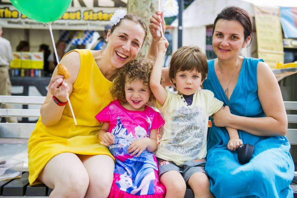 Carmen Jereb of Jerrabomberra with her daughter Maya, 2, and Oana Cozma of the Netherlands with her son Calin, 3, enjoying the festivities. Photo: Jamila Toderas