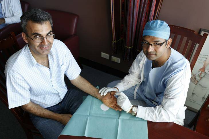 Patient Ali Arezi had his thumb completely cut off in an accident. Doctor Muhammad Ali Hussain, senior registrar of plastic surgery at Canberra Hospital sewed it back on. Photograph of Ali Arezi (from Kaleen) and Doctor Muhammad Ali Hussain. Photo: Katherine Griffiths